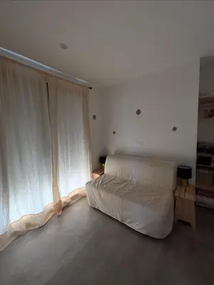 a bedroom with a bed and a large window at Villa DIMA - piscine chauffée climatisation barbecue pétanque in Calenzana
