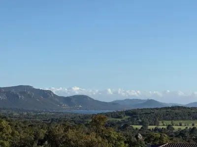 a view of a valley with mountains and a lake at Rondinara Camara - Lecci Lodge in Lecci