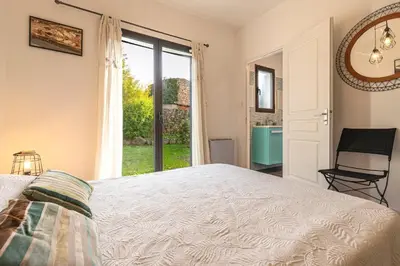 a bedroom with a bed and a window and a chair at Mare e Machja - Maison avec piscine in Cauro