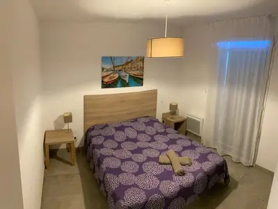 a bedroom with a bed with a cross on it at Villa résidence avec piscine chauffée Bonifacio in Bonifacio