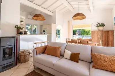 a living room with a couch and a fireplace at Casa Vinti - Vue mer et montagne climatisé in Porticcio