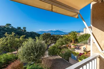 a view from the balcony of a house at Casa Vinti - Vue mer et montagne climatisé in Porticcio