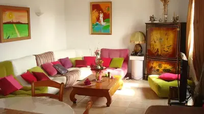 a living room with a couch and a table at Villa conviviale à Olmeto avec piscine privée in Olmeto