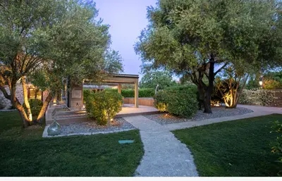 a garden with a gazebo and some trees at Villa Les Granges Classé 5 Étoiles in Antisanti