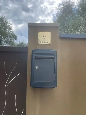 a clock on the side of a wall at Villa Les Granges Classé 5 Étoiles in Antisanti
