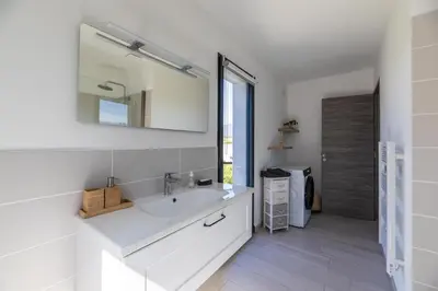 a white bathroom with a sink and a mirror at VILLA BAIA 4-5 pers - 2mn plages - Kids Friendly - Clim - Piscine in Lecci