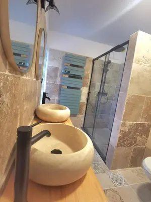 two wooden toilets in a bathroom with a shower at Spacieux haut de villa 3 chambres Venaco in Venaco