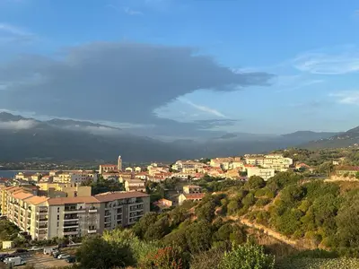 a view of a city with buildings and trees at Superbe vue Mer et Montagne - T3 - 5mn des plages in Propriano