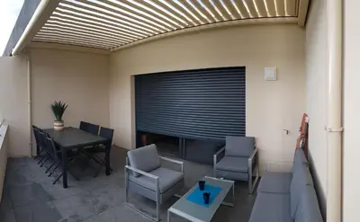 a living room with a couch and a table and chairs at PORTICCIO Appart 6pers Climatisé proche plage in Porticcio