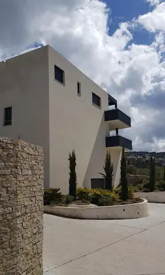a white building with windows on the side of it at PORTICCIO Appart 6pers Climatisé proche plage in Porticcio