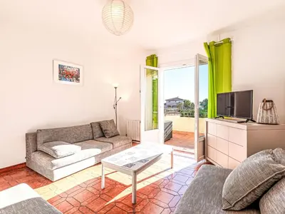 a living room with a couch and a tv at Apartment T3 Gabriello by Interhome in Cala dʼOro