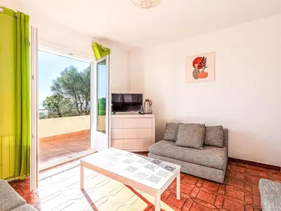 a living room with a couch and a table at Apartment T3 Gabriello by Interhome in Cala dʼOro