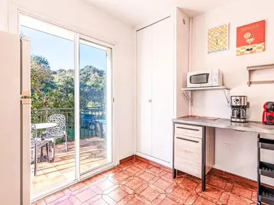 a kitchen with a counter with a microwave at Apartment T3 Gabriello by Interhome in Cala dʼOro