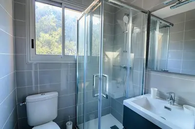 a bathroom with a shower and a toilet and a sink at Beau studio Routes des Sanguinaires proche de la plage in Ajaccio