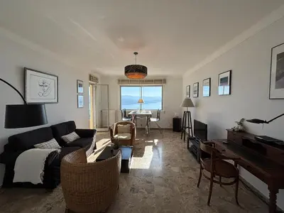 a living room with a couch and a piano at Appartement Parc Belvédère Ajaccio in Ajaccio