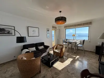 a living room with a couch and chairs and a table at Appartement Parc Belvédère Ajaccio in Ajaccio