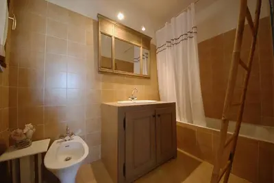 a bathroom with a sink and a toilet at Mini-villa à 5 minutes de la plage de Santa Giulia in Porto-Vecchio
