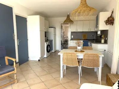 a kitchen and dining room with a table and chairs at Mini-villa à 5 minutes de la plage de Santa Giulia in Porto-Vecchio