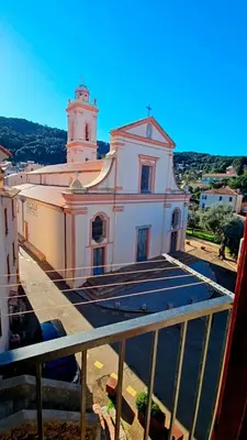 a large white church with a tower on top of it at Splendide T2 Piana in Piana