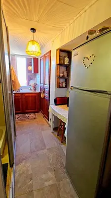a kitchen with a refridgerator and a kitchen with a sink at Splendide T2 Piana in Piana
