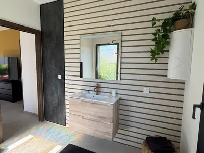a bathroom with a sink and a mirror at Casa Nostra Villa Récente Climatisée - Piscine Chauffée in Lecci