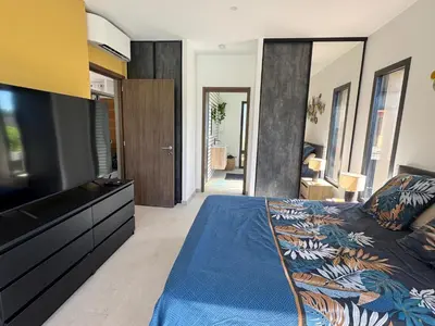 a bedroom with a large television and a bed at Casa Nostra Villa Récente Climatisée - Piscine Chauffée in Lecci
