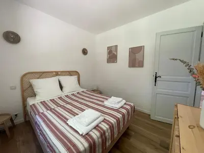a bedroom with a bed with two towels on it at Charmant T2 à la campagne in Riventosa