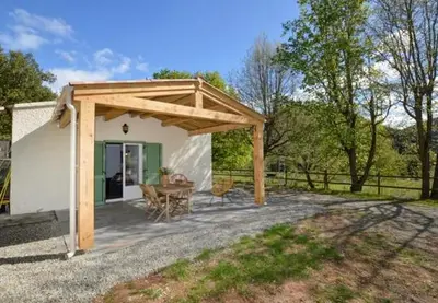 a pavilion with a table and chairs in a backyard at Charmant T2 à la campagne in Riventosa