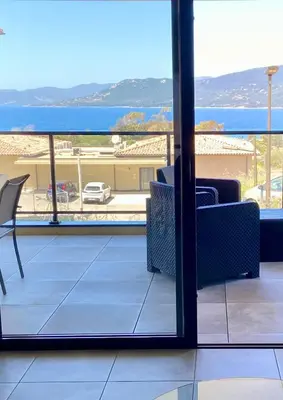 a living room with a view of the ocean at Superbe T3 vue mer in Propriano