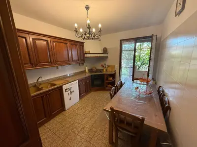 a wooden table with chairs and a bowl of bananas on it at Corse Maison de campagne mer et montagne in Sorbo-Ocagnano