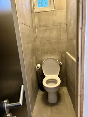 a small bathroom with a toilet in a stall at Casa Straboni Corte in Corte