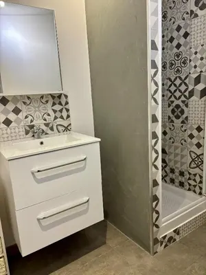a bathroom with a white sink and a shower at Casa Straboni Corte in Corte