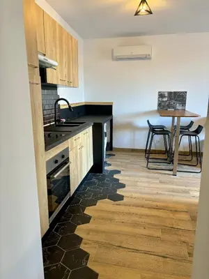 a kitchen with wooden cabinets and a table with chairs at Casa Straboni Corte in Corte