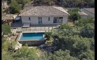 an aerial view of a house with a swimming pool at Villa ALMA in Porto-Vecchio
