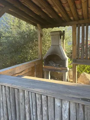 an outdoor oven sitting on a wooden deck at Villa ALMA in Porto-Vecchio
