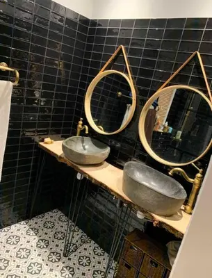 a bathroom with two sinks and two mirrors at Villa ALMA in Porto-Vecchio