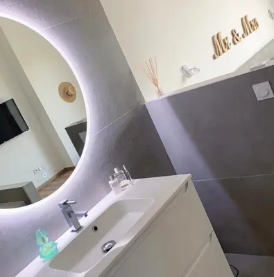 a bathroom with a sink and a mirror at MaisonDrs in Porto-Vecchio