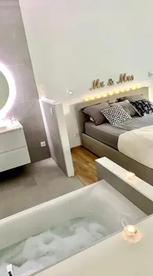 a bedroom with a bed and a bath tub in a room at MaisonDrs in Porto-Vecchio