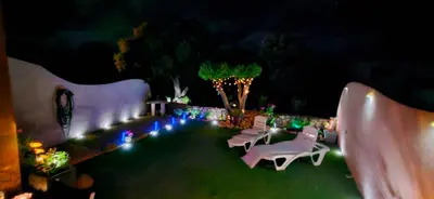 a yard with white chairs and trees in front of a house at Porto Vecchio - Résidence RIVIERA - Villa Pinarello in Lecci