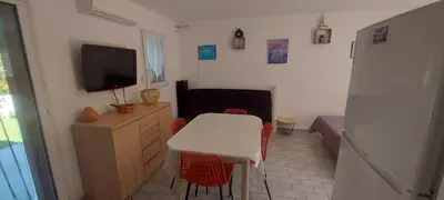 a small room with a table and a television at Porto Vecchio - Résidence RIVIERA - Villa Pinarello in Lecci