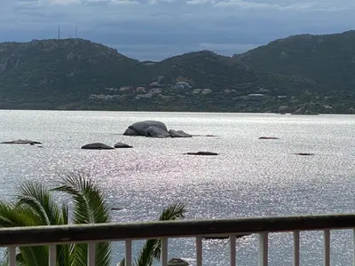 a view of a body of water with mountains at Les oliviers 11 Appartement, bord de mer, porto-vecchio in Porto-Vecchio