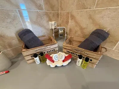 two wooden crates with bottles of wine in a bathroom at Les oliviers 11 Appartement, bord de mer, porto-vecchio in Porto-Vecchio