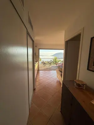 a hallway with a room with a view of the ocean at Les oliviers 11 Appartement, bord de mer, porto-vecchio in Porto-Vecchio