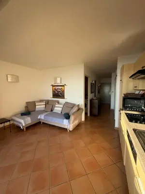 a living room with a couch and a table at Les oliviers 11 Appartement, bord de mer, porto-vecchio in Porto-Vecchio