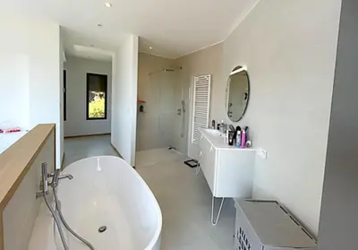 a white bathroom with a tub and a sink at Villa Cazélie, piscine vue splendide sur le Golfe in Porto-Vecchio