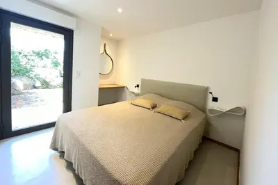 a bedroom with a bed with two pillows on it at Villa Cazélie, piscine vue splendide sur le Golfe in Porto-Vecchio