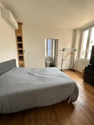 a bedroom with a bed and a television in it at Superbe appartement en centre ville in Corte