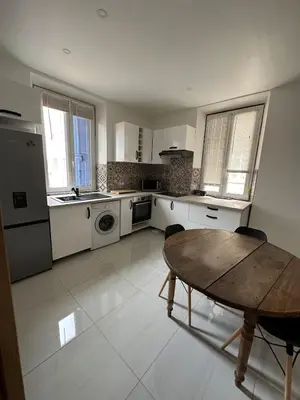 a large kitchen with a wooden table and a table sidx sidx sidx at Superbe appartement en centre ville in Corte