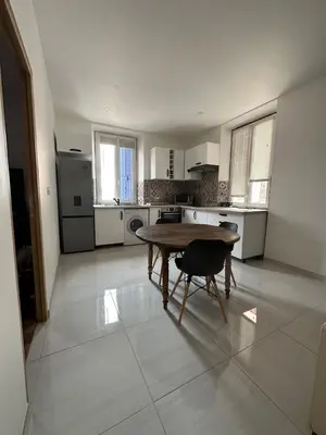 a large kitchen with a wooden table and a table sidx sidx sidx sidx at Superbe appartement en centre ville in Corte