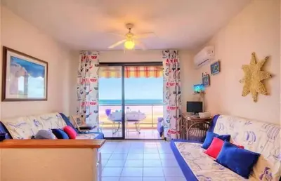 a living room with a couch and a view of the ocean at Studio accueillant à San-Nicolao avec vue mer, 27 m² in San-Nicolao